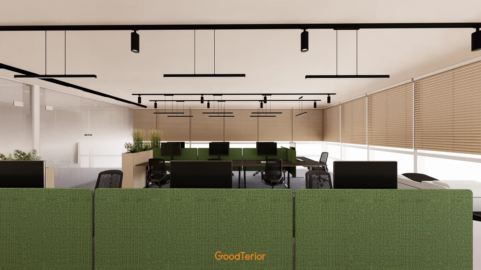 An office design with beige blinds on windows extending behind and to the right of green desk screens